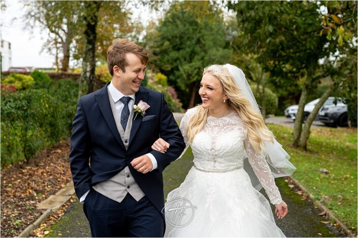 Bride and groom walking and having a laugh