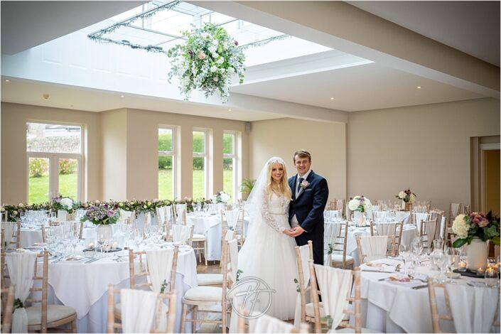 Bride and groom in wedding breakfast room